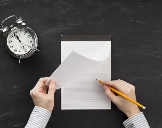 student-writing-empty-notepad student-writing-empty-notepad